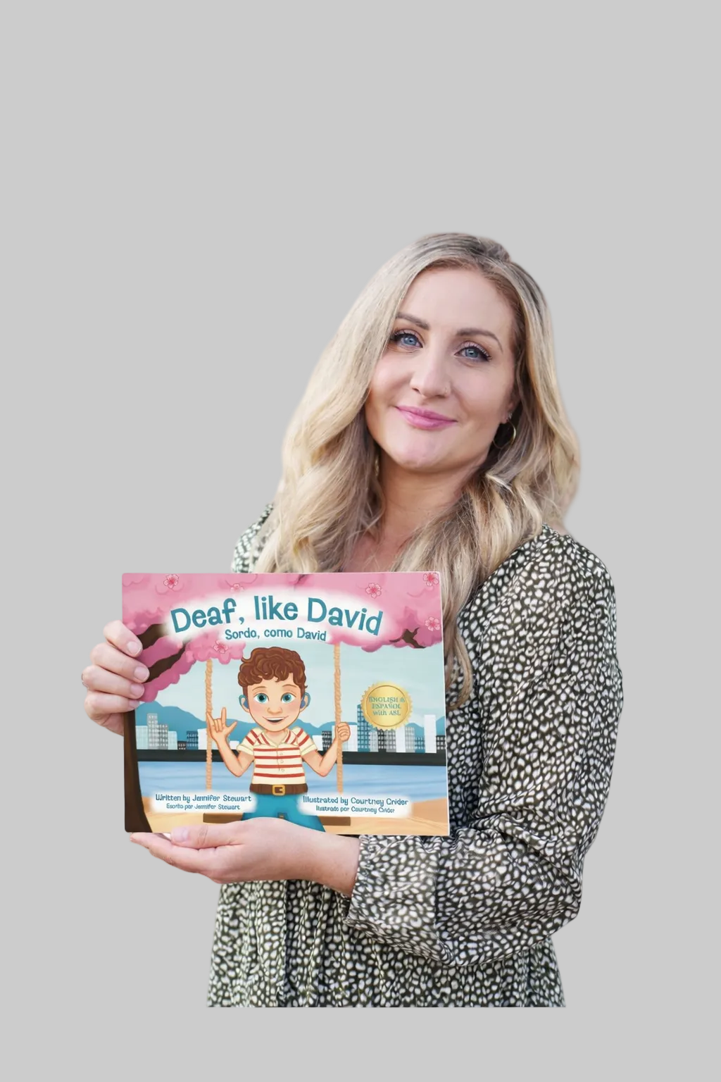 Woman holding a book titled 'Deaf, Like David' on a white background